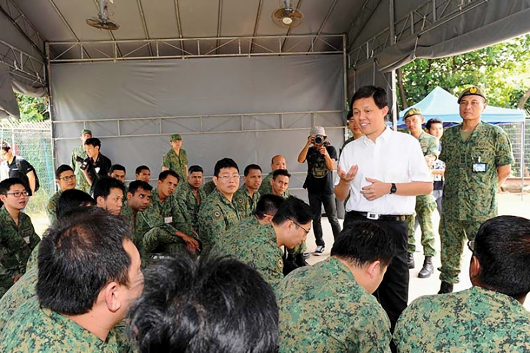 Chan Chun Sing, then Singapore’s second minister for defence, left, in white shirt, speaks with Operationally-Ready National Servicemen from the 807th Battalion, Singapore Infantry Regiment in January 2015, stressing the importance of remaining vigilant against terrorism. SINGAPORE MINISTRY OF DEFENCE 